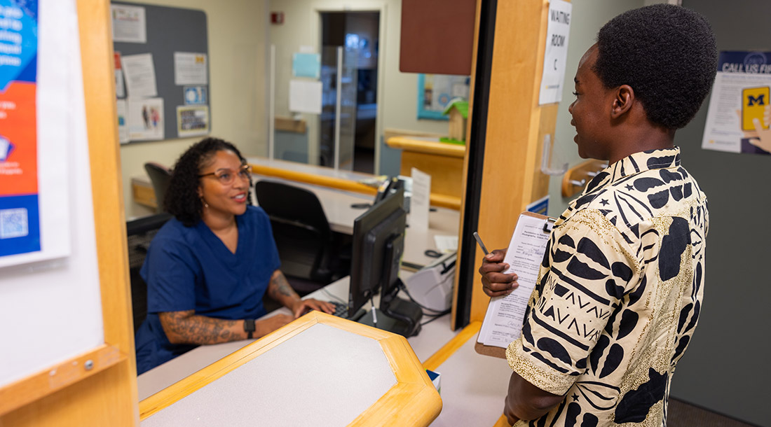 front-desk-staff-talking-to-young-patient